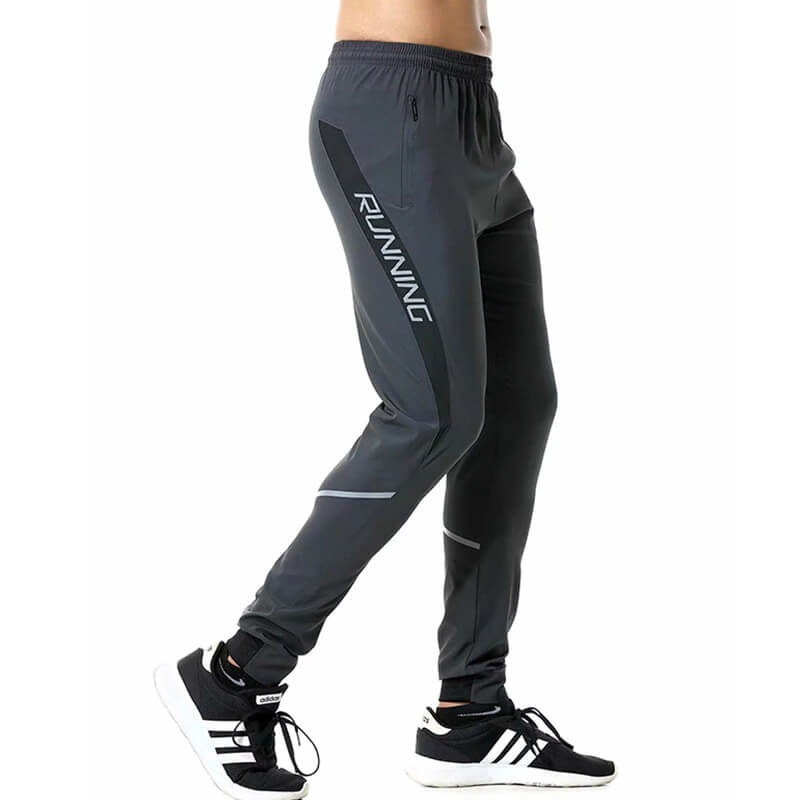 Men's casual running joggers in gray with zipper pockets, perfect for exercise. Elastic waistband ensures comfort and full-length coverage.